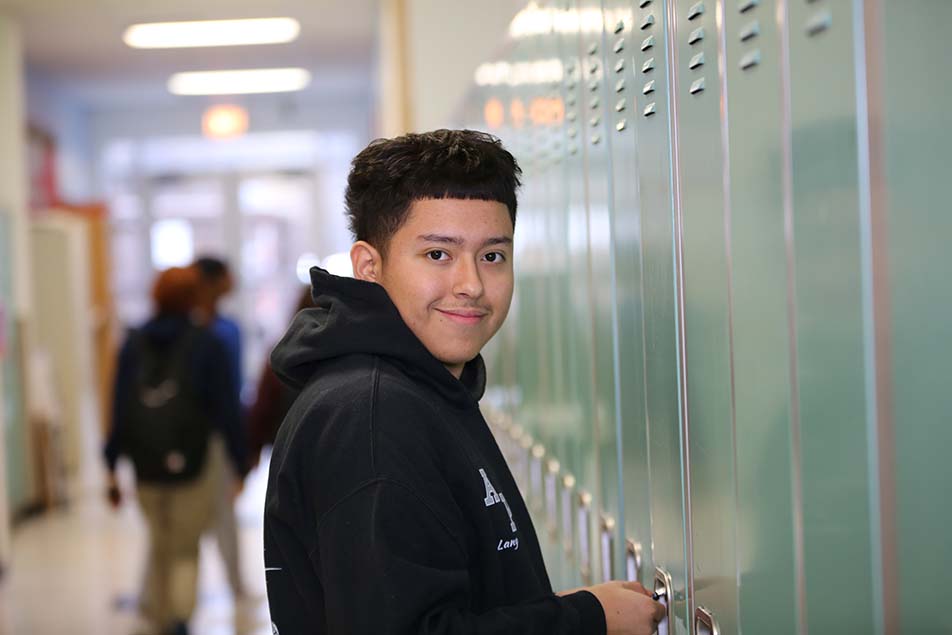 student in classroom smiling at camera