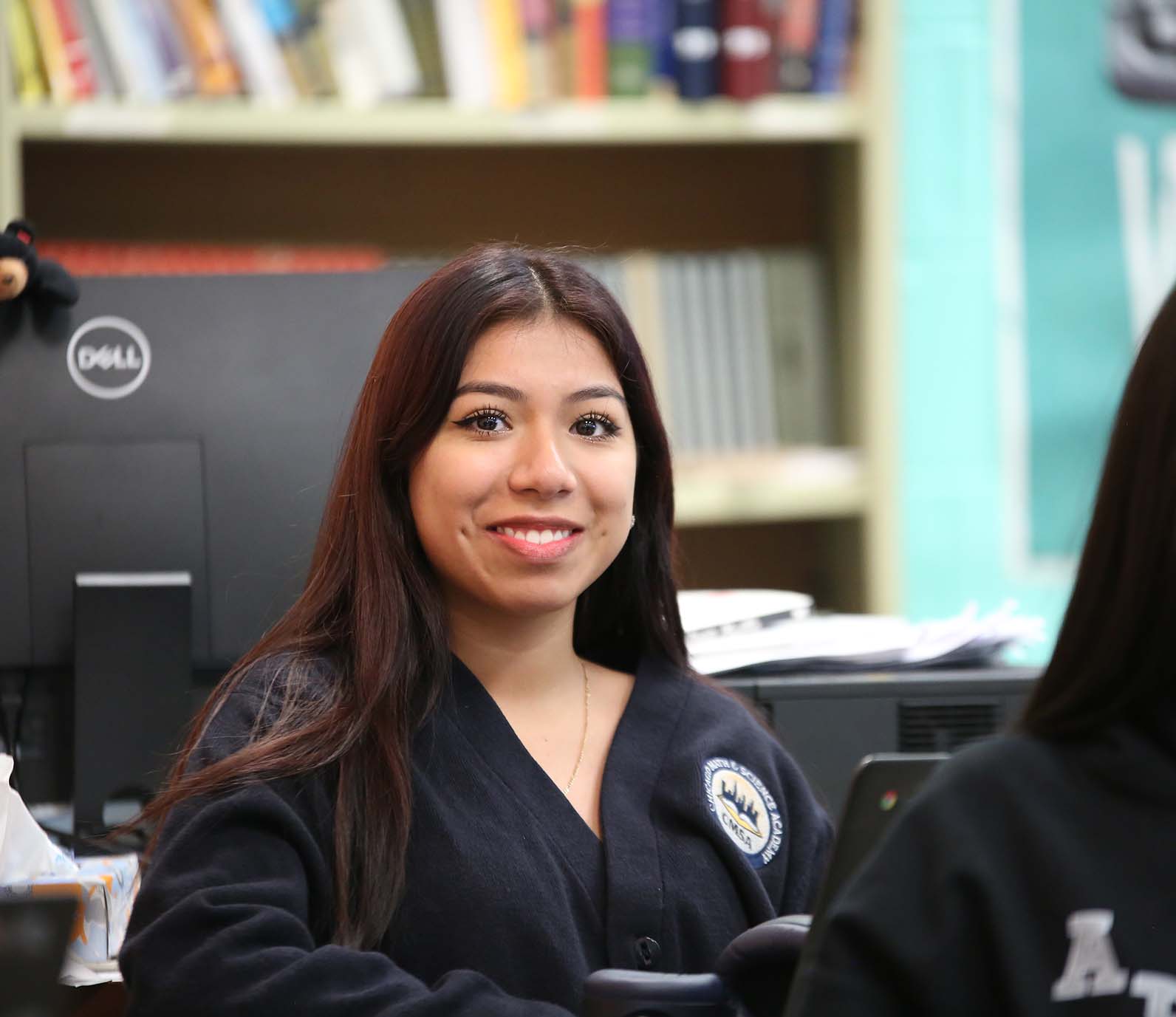 CMSA student wearing headphones uses a laptop in class